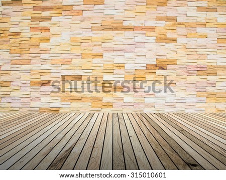 perspective wood plank floor with over blur Brick wall background