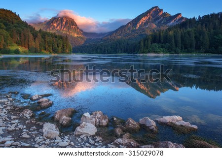 Amazing summer morning on the fantastic Swiss lake Obersee, located near Nafels village. Alps, Switzerland, Europe.