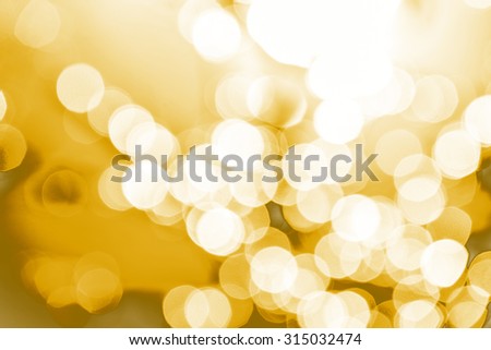 Abstract Bokeh gold natural light background texture.