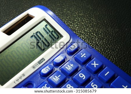 The old and dirty blue color calculator represent the calculation equipment and new year concept related idea. 