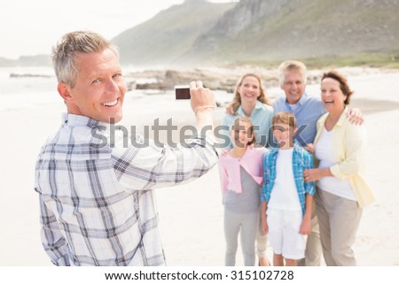 Multi generation family taking a picture at the beach