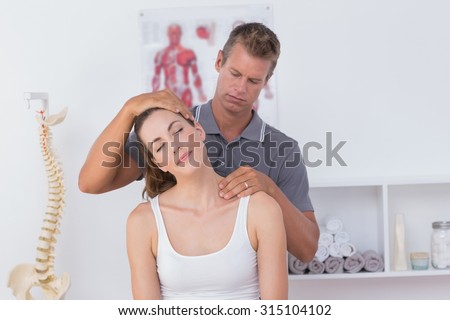 Close up of doctor doing neck adjustment in medical office Royalty-Free Stock Photo #315104102