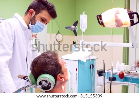Mending patient's teeth, Dentist fixes the patient's teeth, Photography
