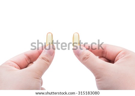Omega 3 fish oil capsule hold by a two hand