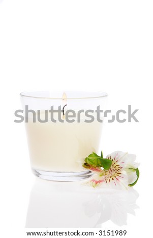 Burning Candle and orchid on white