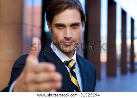 Attractive Businessman with hand outstretched