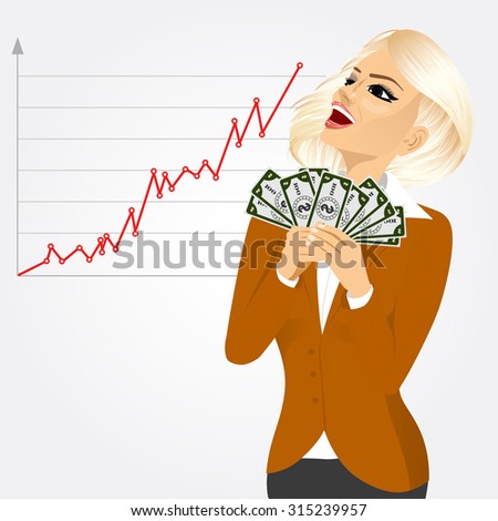 blonde businesswoman really happy enjoying and holding big fan of money with both hands looking at business diagram graph chart