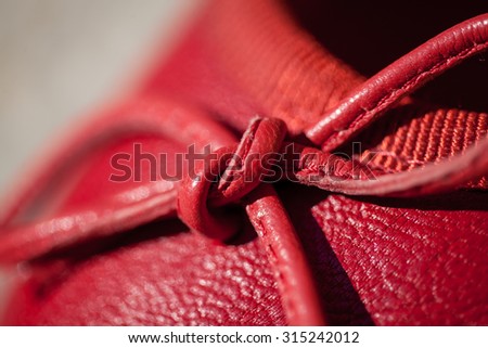 Color picture of a red leather female shoe with red leather lace