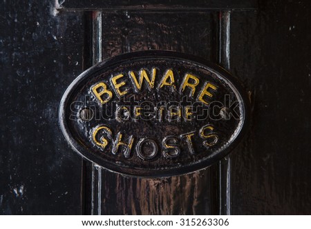A Beware of the Ghosts plaque on the entrance to the Golden Fleece public house in York, England. It is regarded to be the most haunted pub in York.