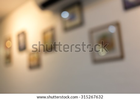 abstract blurred photo frame hanging on white wall, decoration interior in restaurant