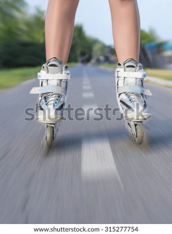 Legs of beautiful girl with roller skate in park, motion blur effect