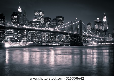The Brooklyn Bridge against the Manhattan skyline in the early evening.