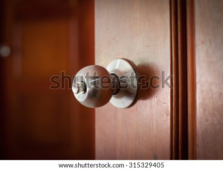 door handle keyhole with old design on brown wood door