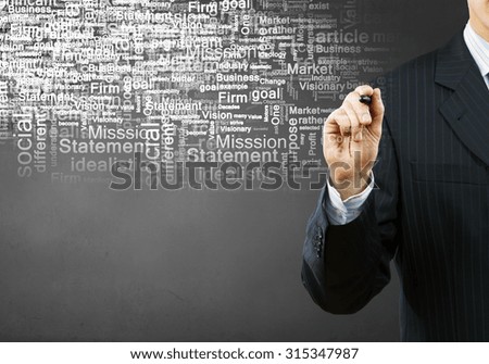 Businessman hand writing words on media screen