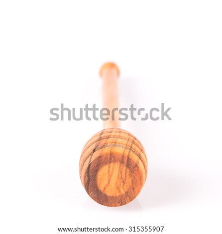 Wooden honey dipper over white background