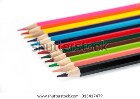 Colored pencils lined up on a white background.