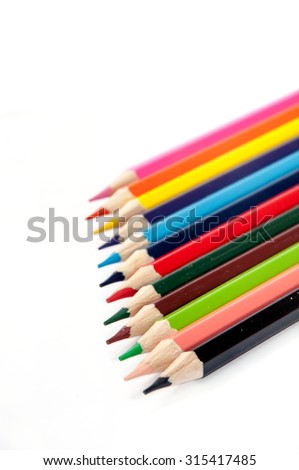 Colored pencils lined up on a white background.