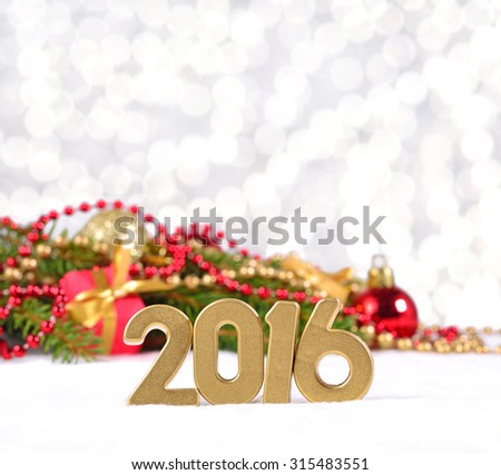 2016 year golden figures and spruce branch and Christmas decorations