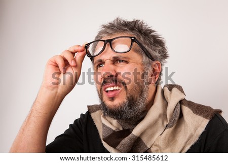 Old grumpy man with beard and big nerd glasses 