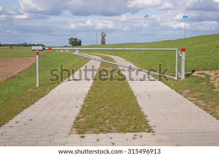 Rural road with closed barrier