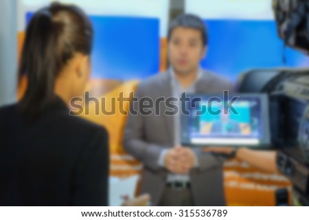 Motion blur of journalist interview an analyst 