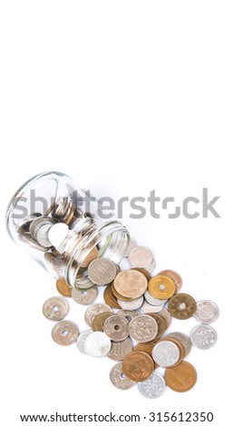 Japanese Yen coins in a mason jar over white background