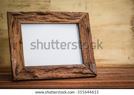 Wood picture frame on wooden background