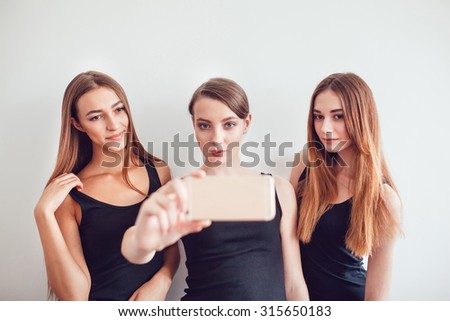 Beautiful Young Girls Taking a Selfie Photo with Phone