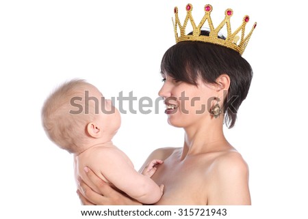Mother holds baby, isolated on white background. Mother wearing crown on a head. Happiness concept.