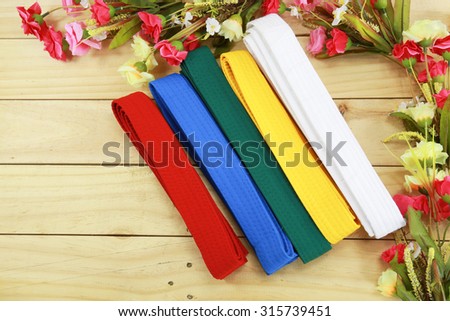 Color belt of martial art on wood floor Royalty-Free Stock Photo #315739451