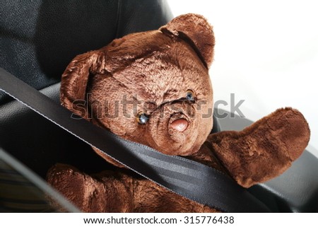 The bear doll in action of fall down the head to the car steering represent the car accident concept related idea. 
