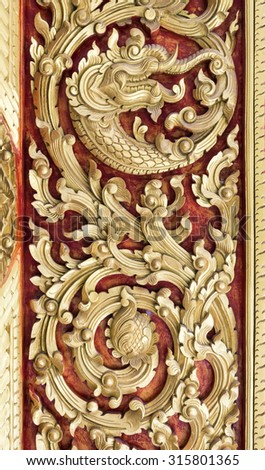Golden pattern  carving on front door of the public Thai temple.