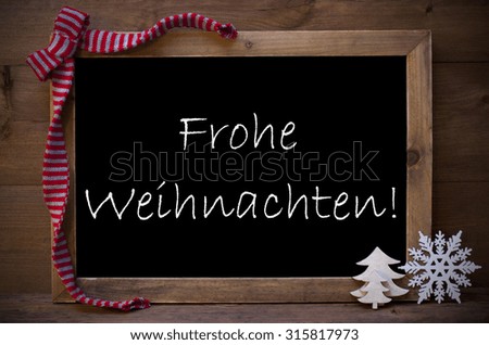 Brown Christmas Blackboard With German Text Frohe Weihnachten Means Merry Christmas As Greeting Card. Christmas Decoration, Christmas Tree, Snowflake Red Loop. Wooden Background. Vintage Rustic Style.
