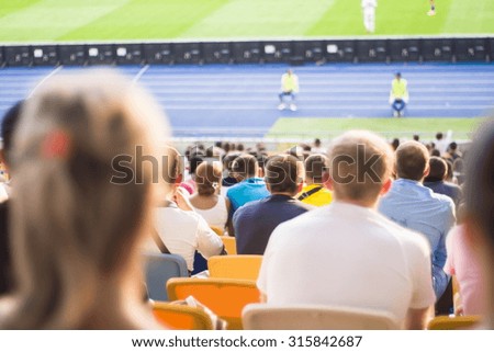 Spectators sit in the stadium