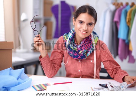 Clothes designer at work Royalty-Free Stock Photo #315871820