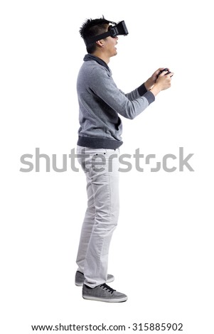 Male immersed in interactive virtual reality video game doing gestures on white background.  He is wearing a stereoscopic 3d vr headset.