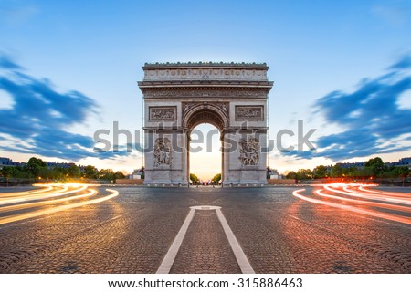 Paris street at night with the Arc de Triomphe in Paris, France. Royalty-Free Stock Photo #315886463