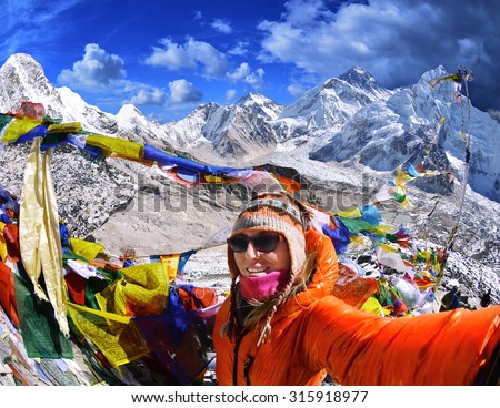 Smiling young woman takes a selfie  on mountain peak  Kala Patthar in Nepal 
A view of Mt. Everest and Khumbu Glacier  Royalty-Free Stock Photo #315918977