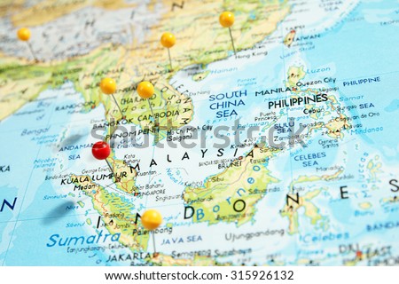 Pins on map with focus on Kuala Lumpur city, Malaysia Royalty-Free Stock Photo #315926132