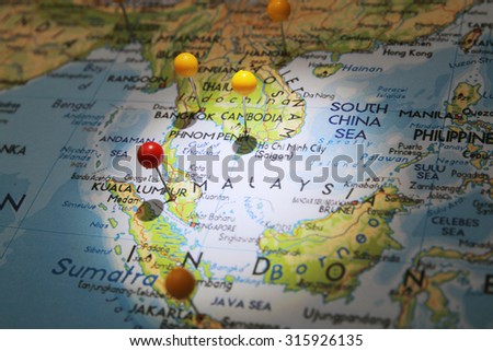 Map pins on map with focused light and red pin on Kuala Lumpur city Royalty-Free Stock Photo #315926135