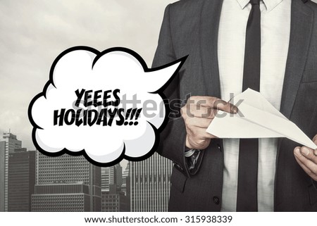 Yeees holidays text on speech bubble with businessman holding paper plane in hand on city background