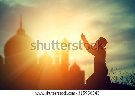 Silhouette muslim boy praying faith in allah God of islam supremely. Royalty-Free Stock Photo #315950543