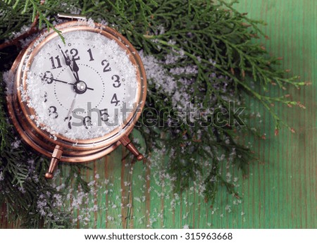 Christmas composition with fir branches, decorations and old clock