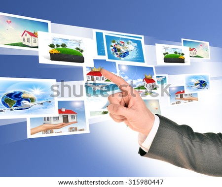 Businessmans arm with holographic pictures on abstract background