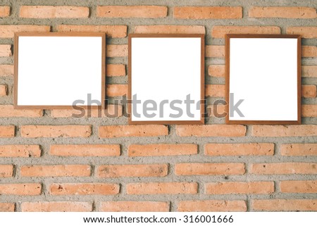 blank brown picture frameon ple brick wall