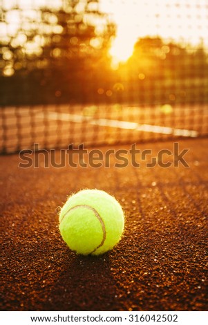Close up of tennis ball on clay court./Tennis ball Royalty-Free Stock Photo #316042502