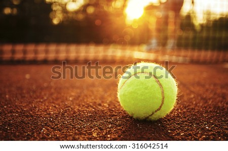 Close up of tennis ball on clay court./Tennis ball Royalty-Free Stock Photo #316042514