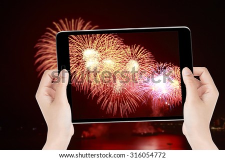 Touch screen the tablet photography a fireworks.