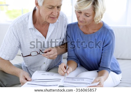 Senior couple doing home finances Royalty-Free Stock Photo #316065857