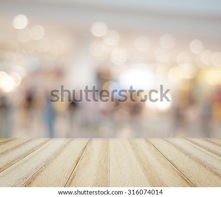 Wood floor and blurred shopping mall background